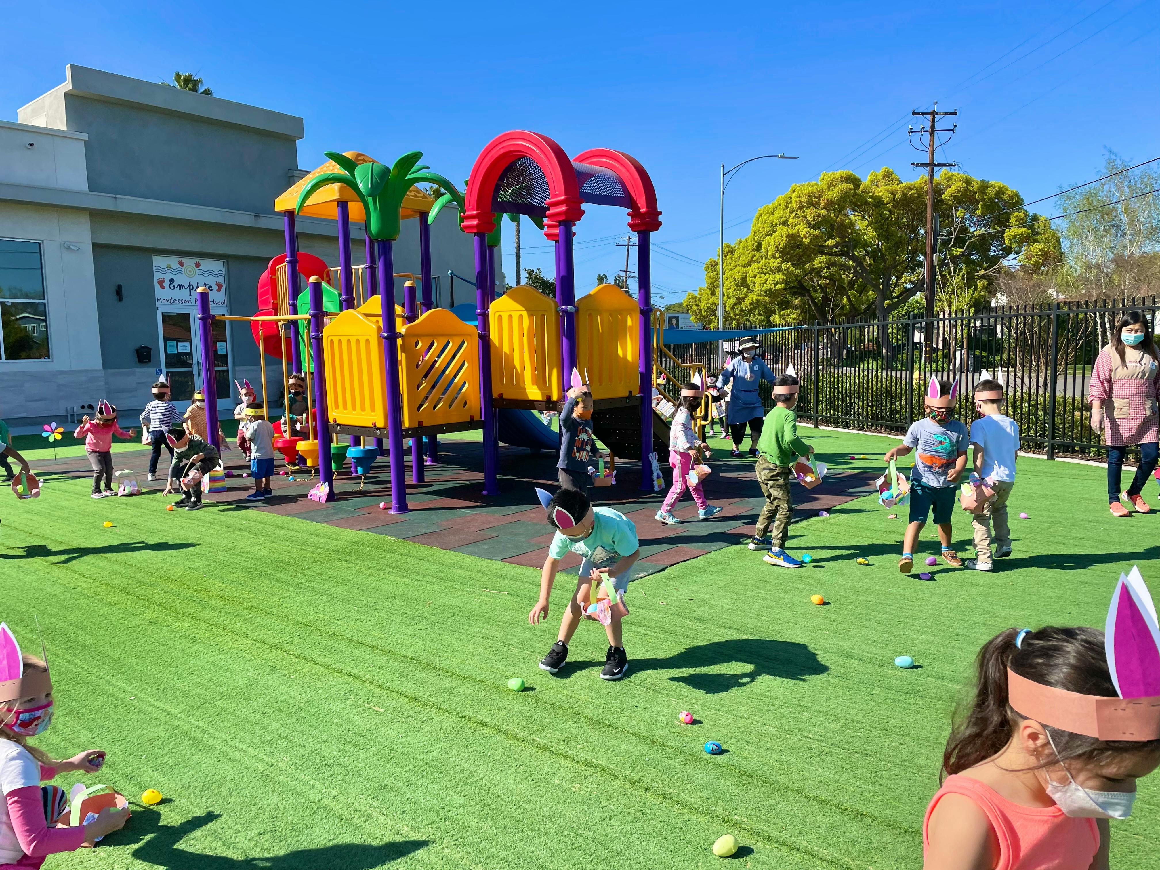 Children on a playground with colorful play structures