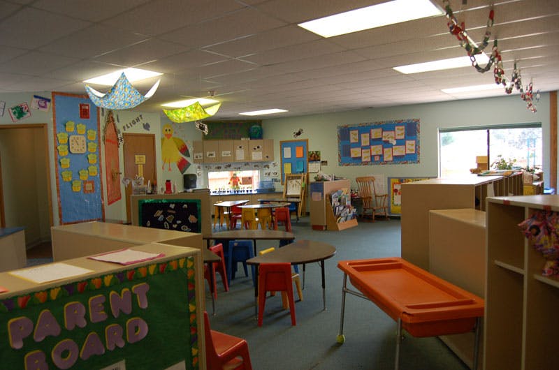 Empty classroom with small tables and chairs