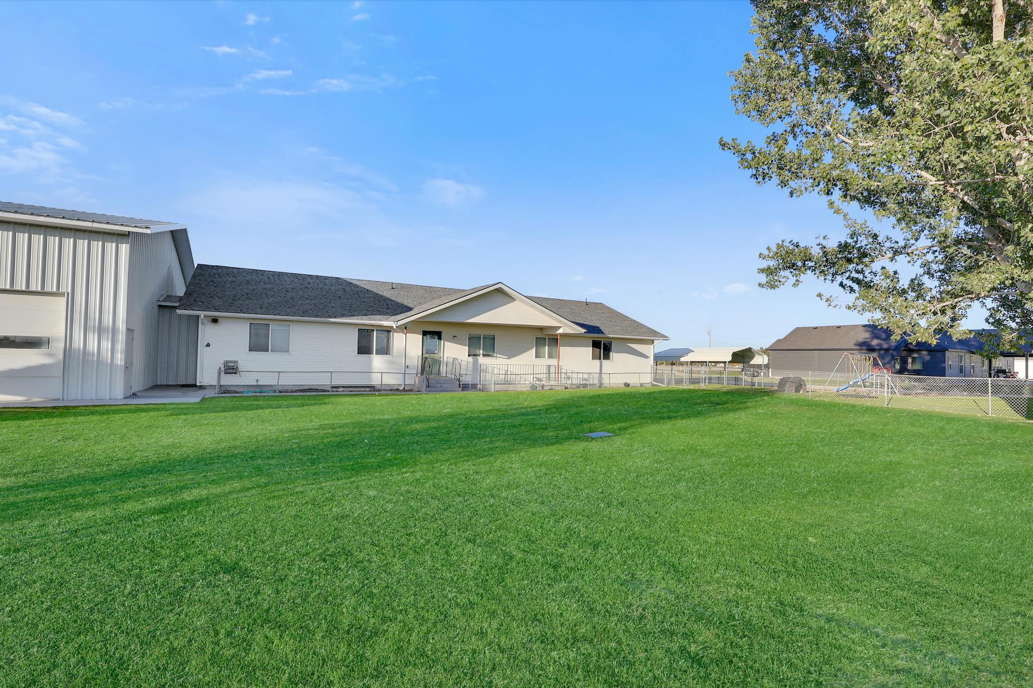 House with an attached garage and a large grassy yard