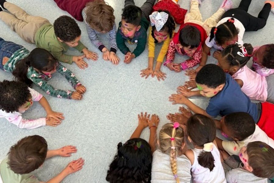 Group of children lying on the floor in a circle