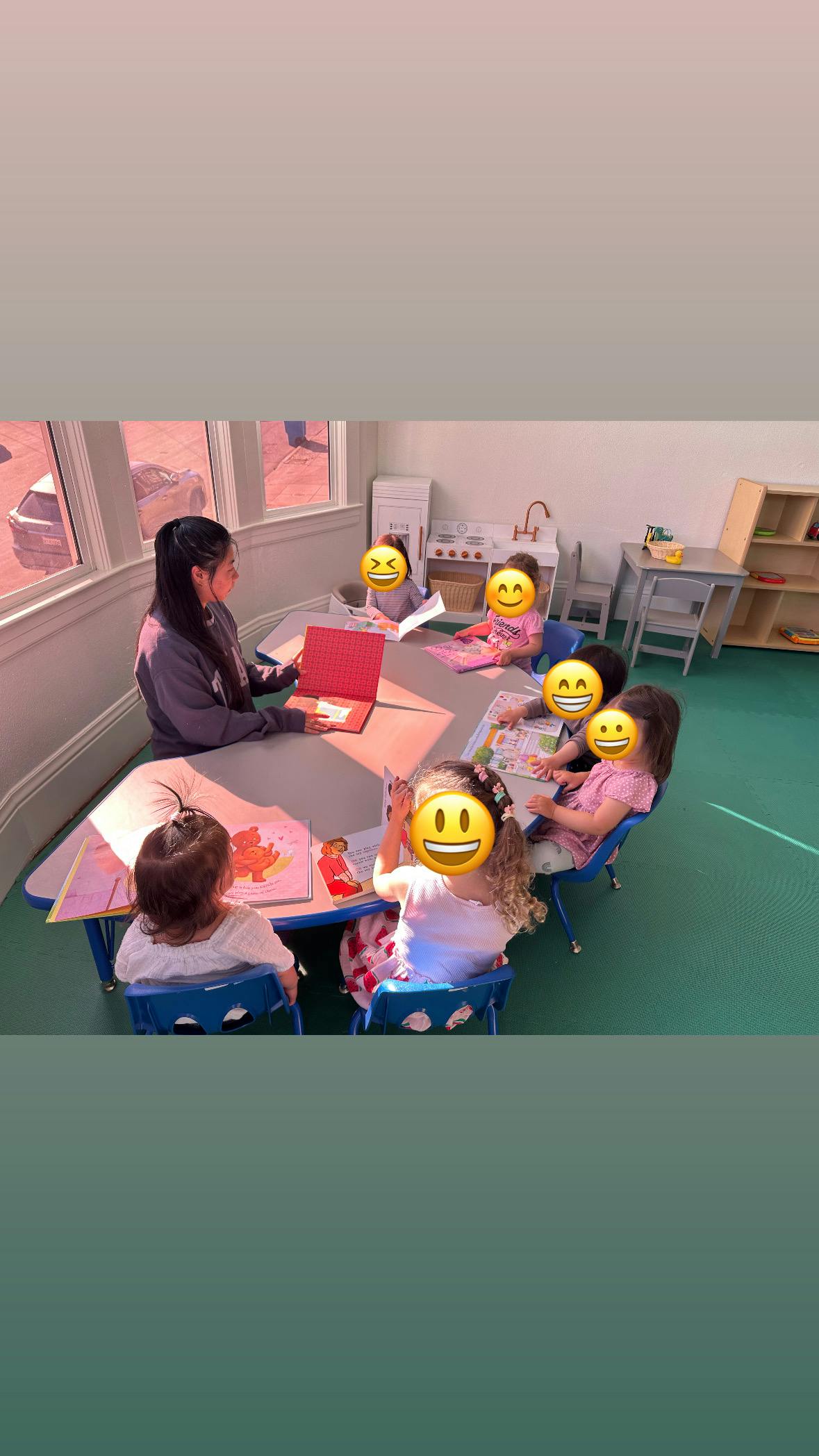Person with children at a table in a classroom
