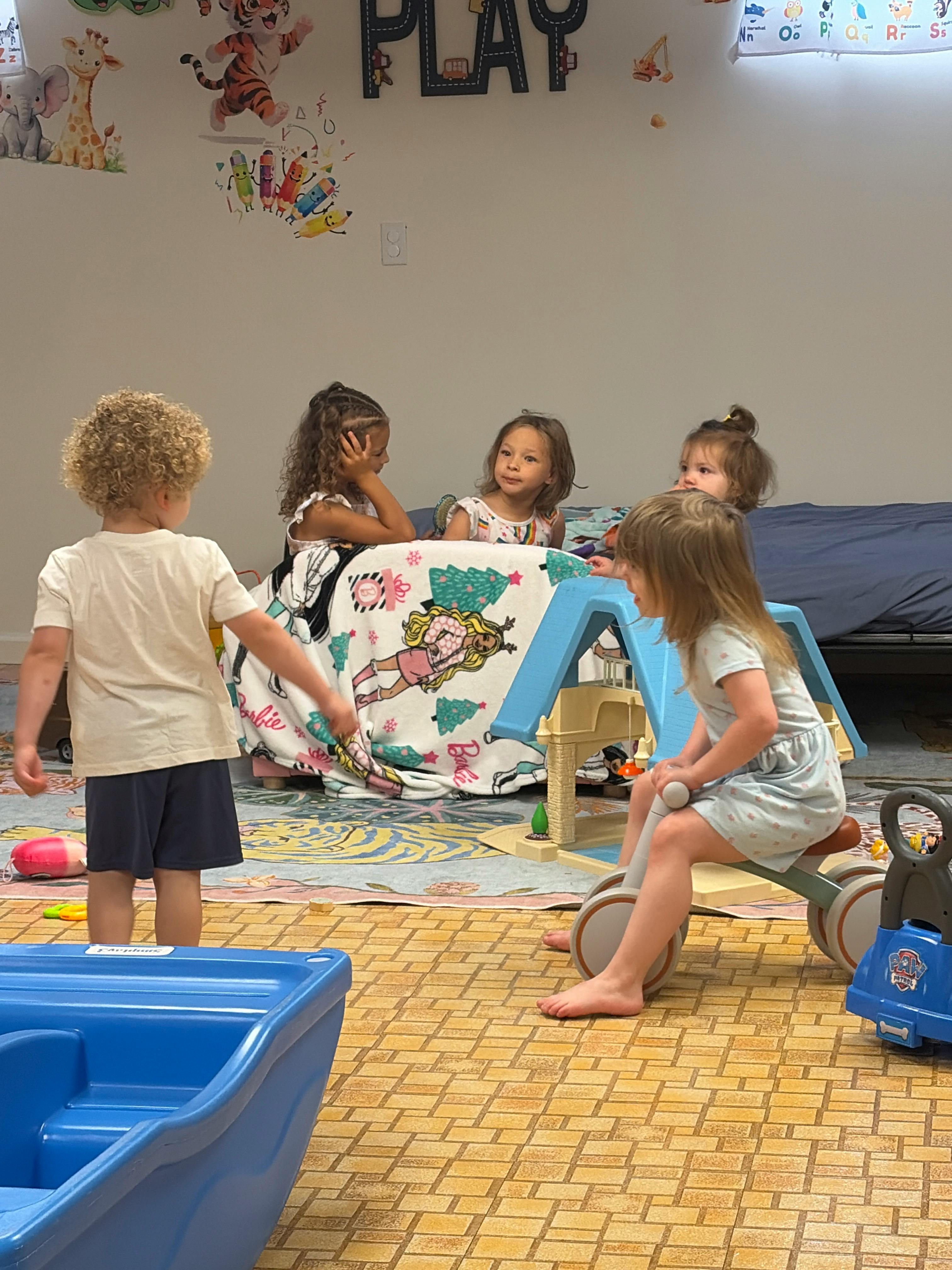 Four children playing together in a room