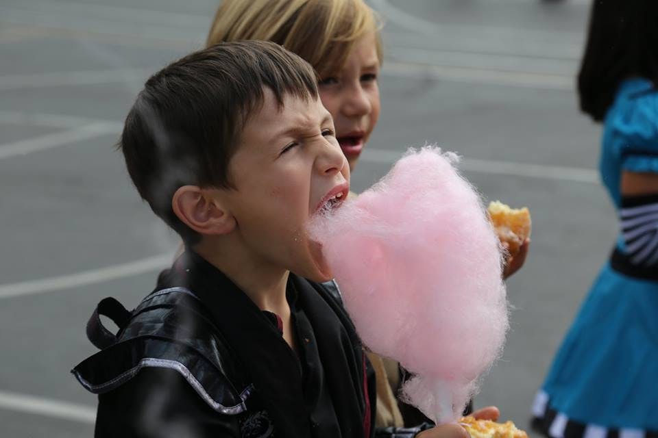 Child eating pink cotton candy