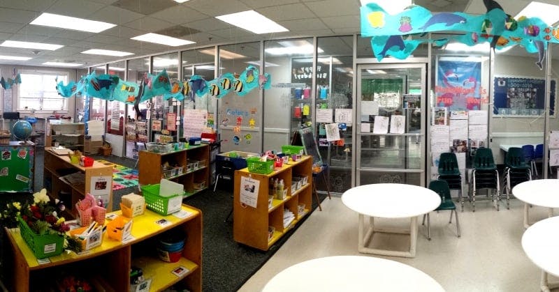 Classroom with tables, shelves, and decorations