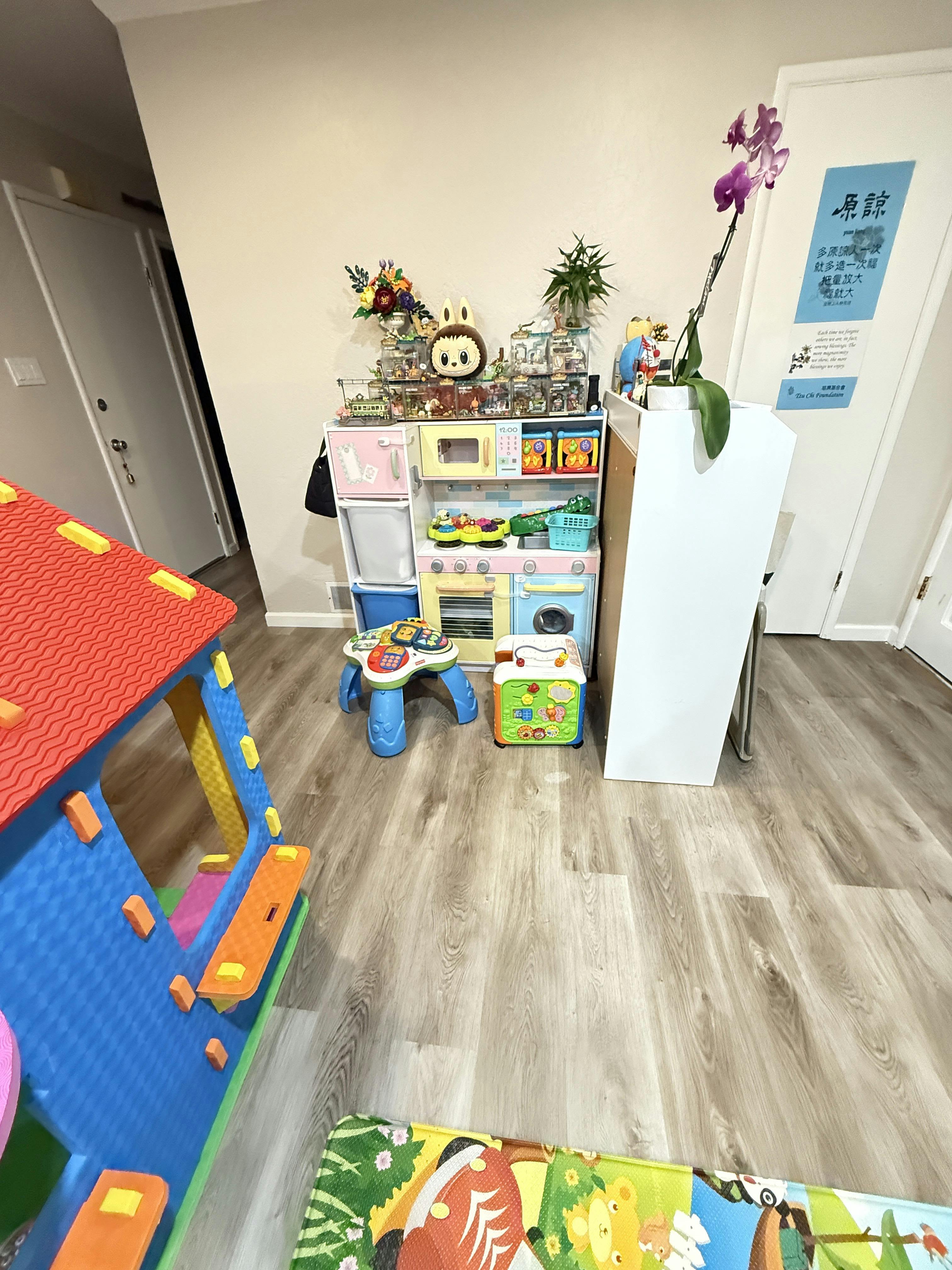 Children's play kitchen and slide in a room