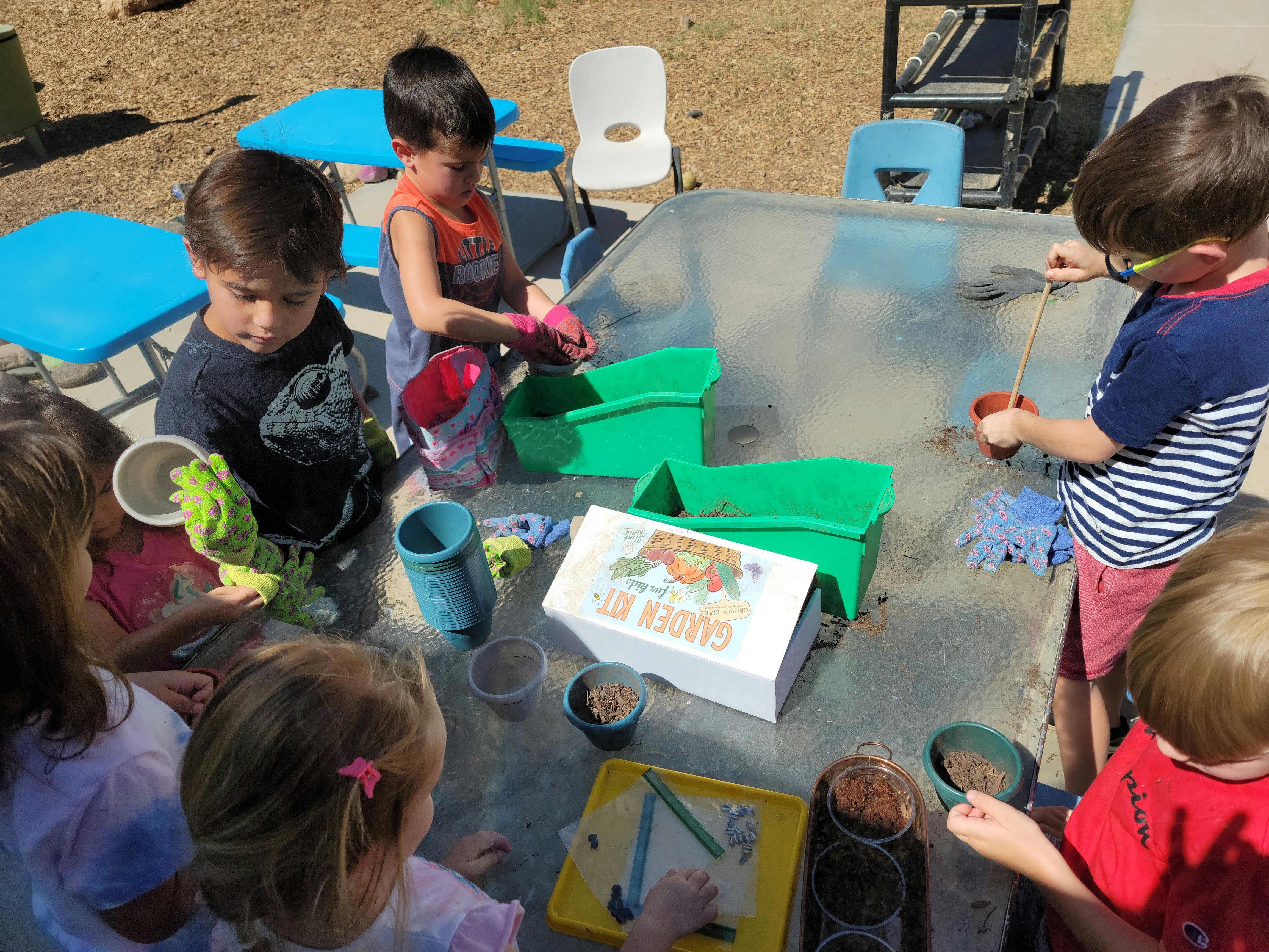 Children playing at a water table outdoors