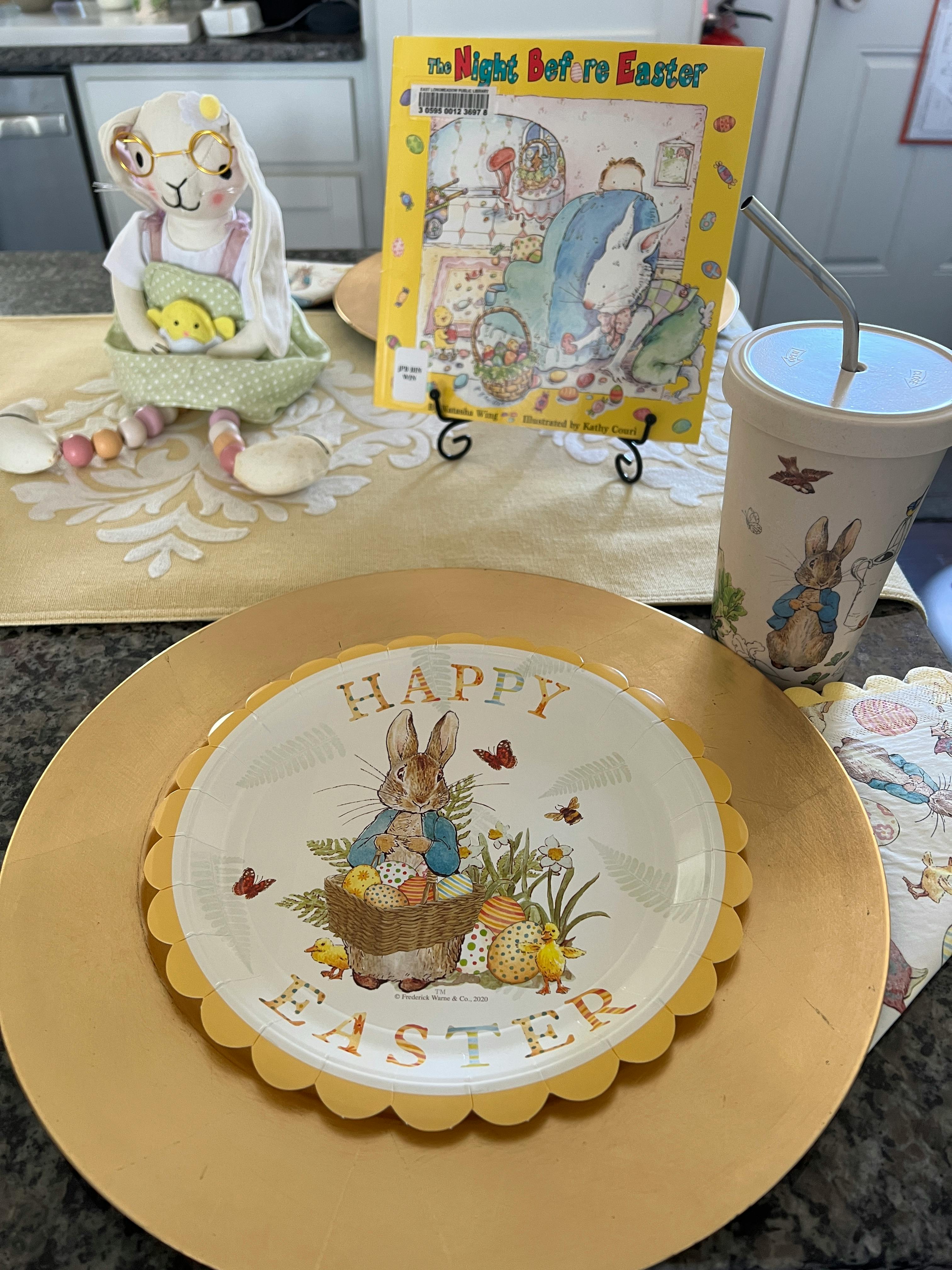Easter themed decorations including a plate, book, and stuffed animal