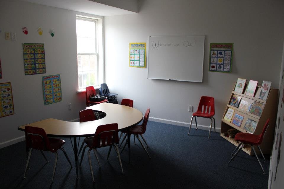 Classroom with a curved table and red chairs