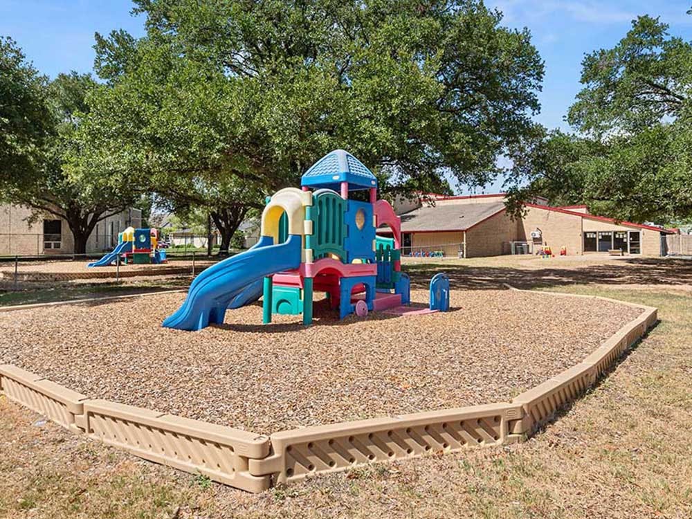 Colorful playground with two slides and a beige border