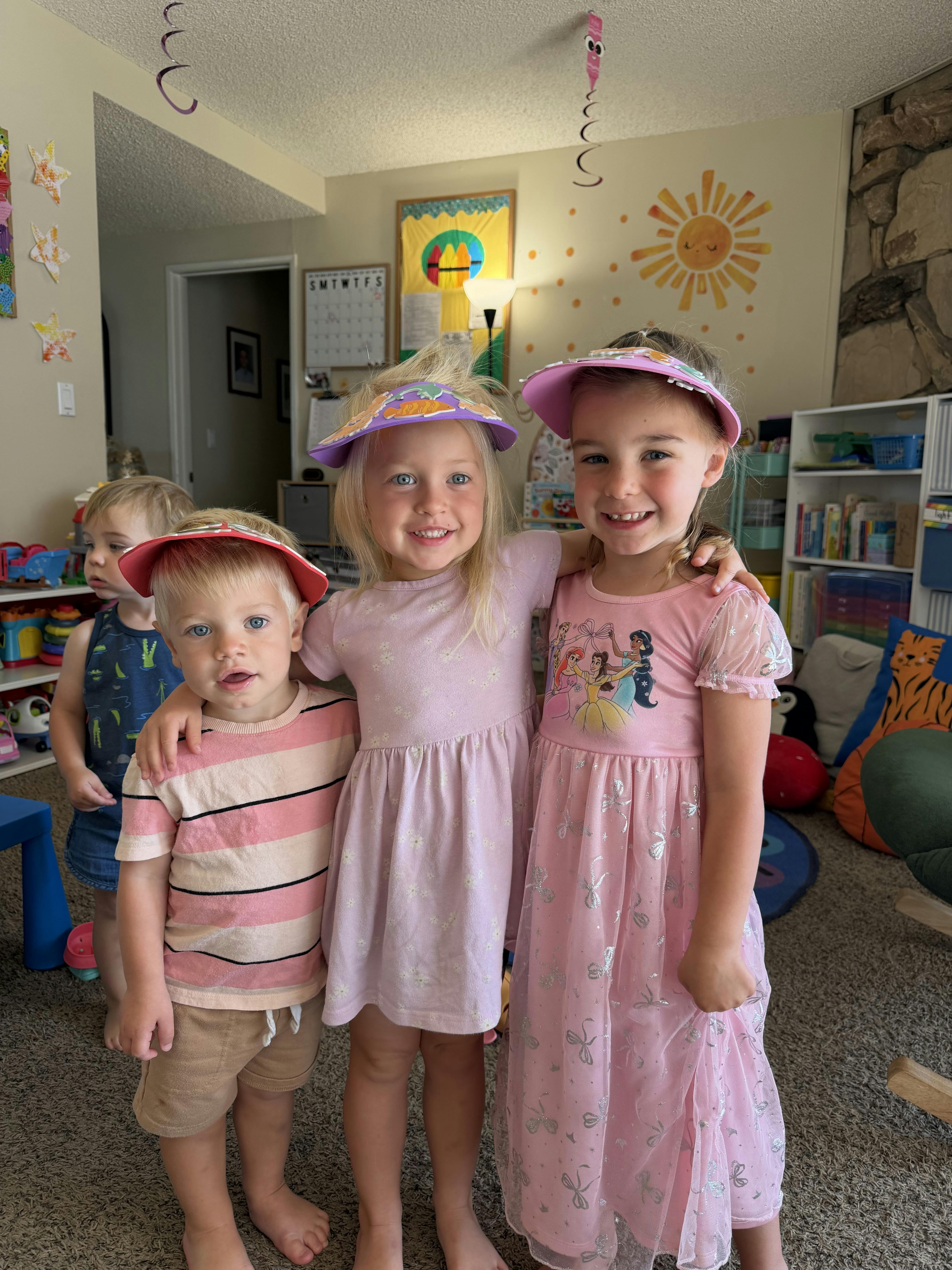 Group of children wearing paper visors in a play area