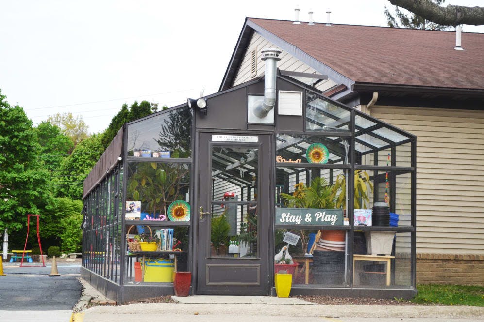 Greenhouse with a "Stay & Play" sign