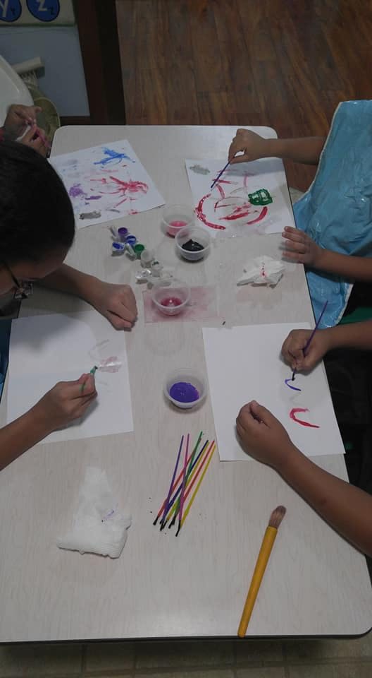 Children painting at a table