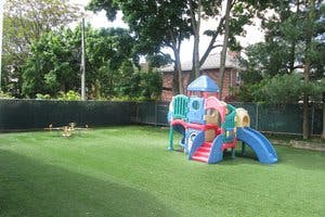 Colorful playground structure with slides on green grass