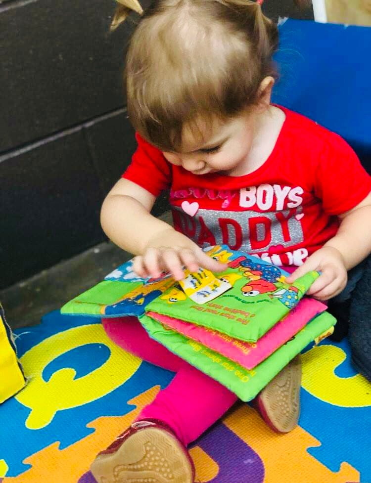 Child playing with a soft book