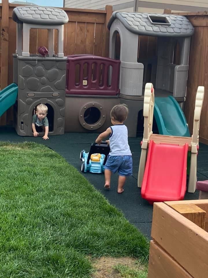Two children playing on a playground structure