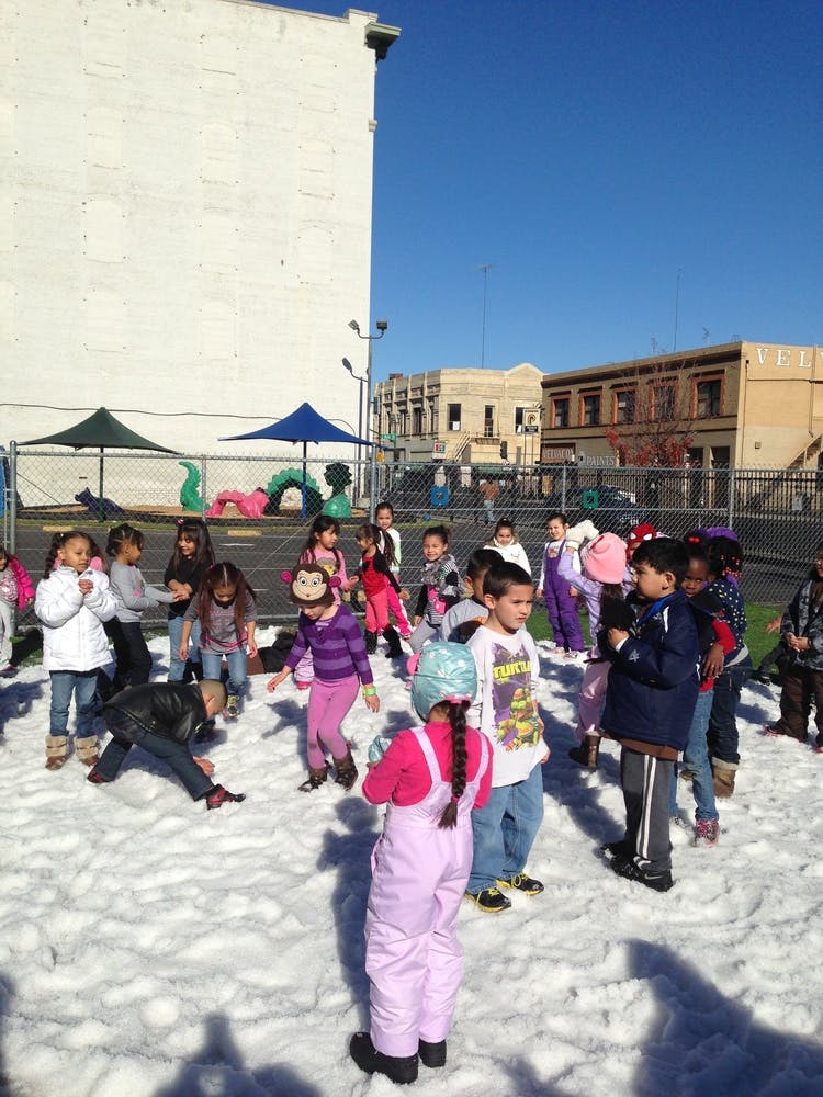 Children playing in snow on a sunny day