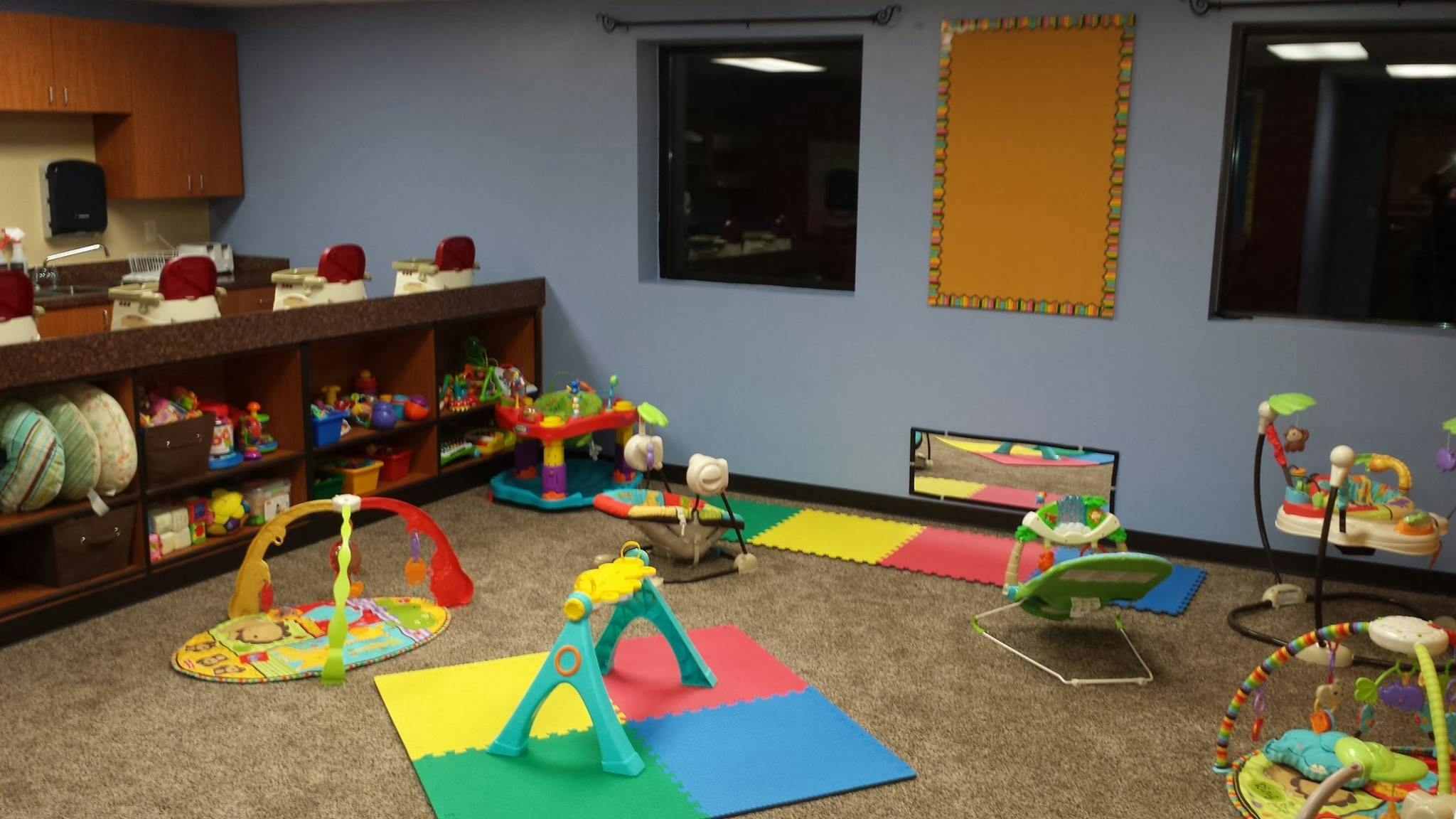 Playroom with colorful mats and various baby toys