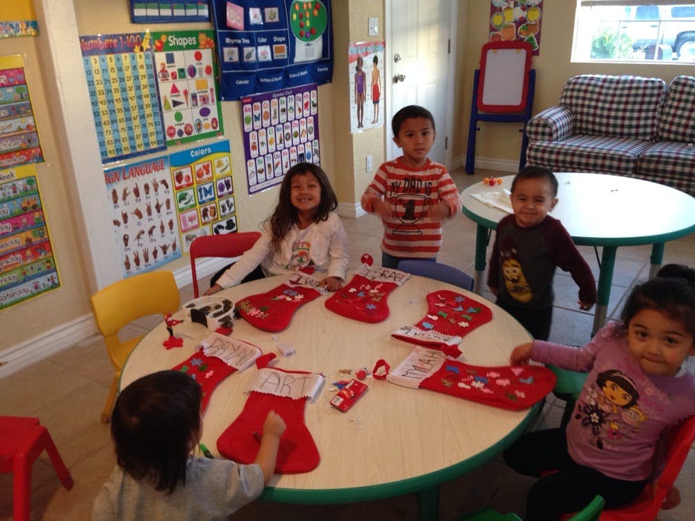 Children decorating Christmas stockings in a classroom