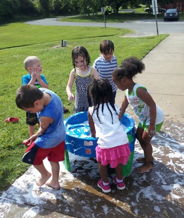 Children playing with a water table outdoors
