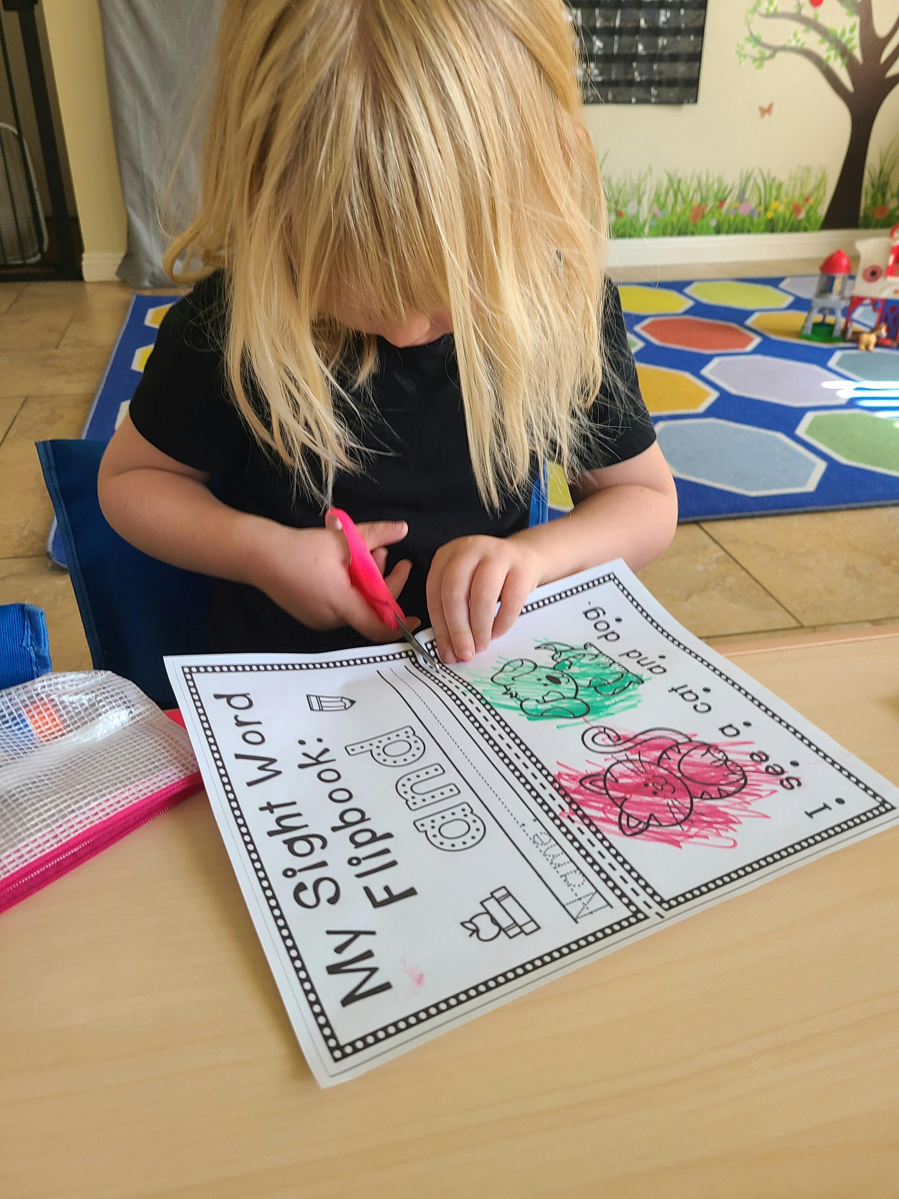 Child cutting paper with scissors