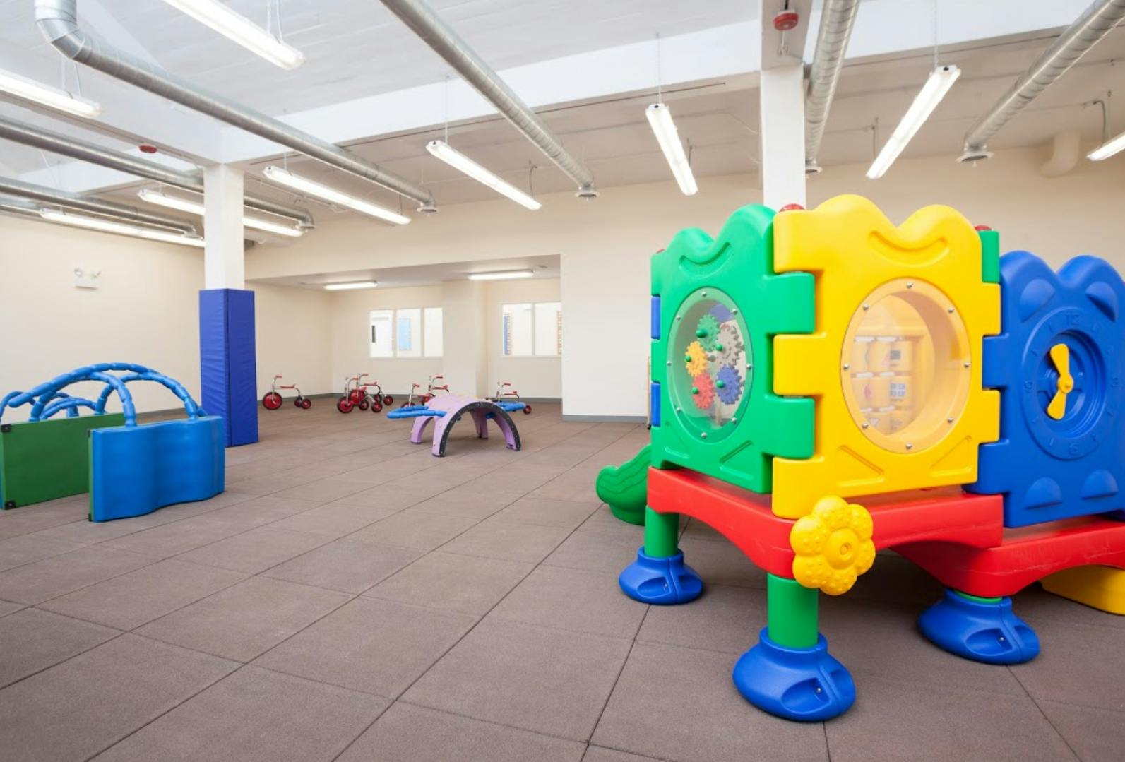 Indoor play area with colorful plastic play structures