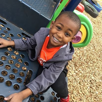 Child on a playground climbing structure