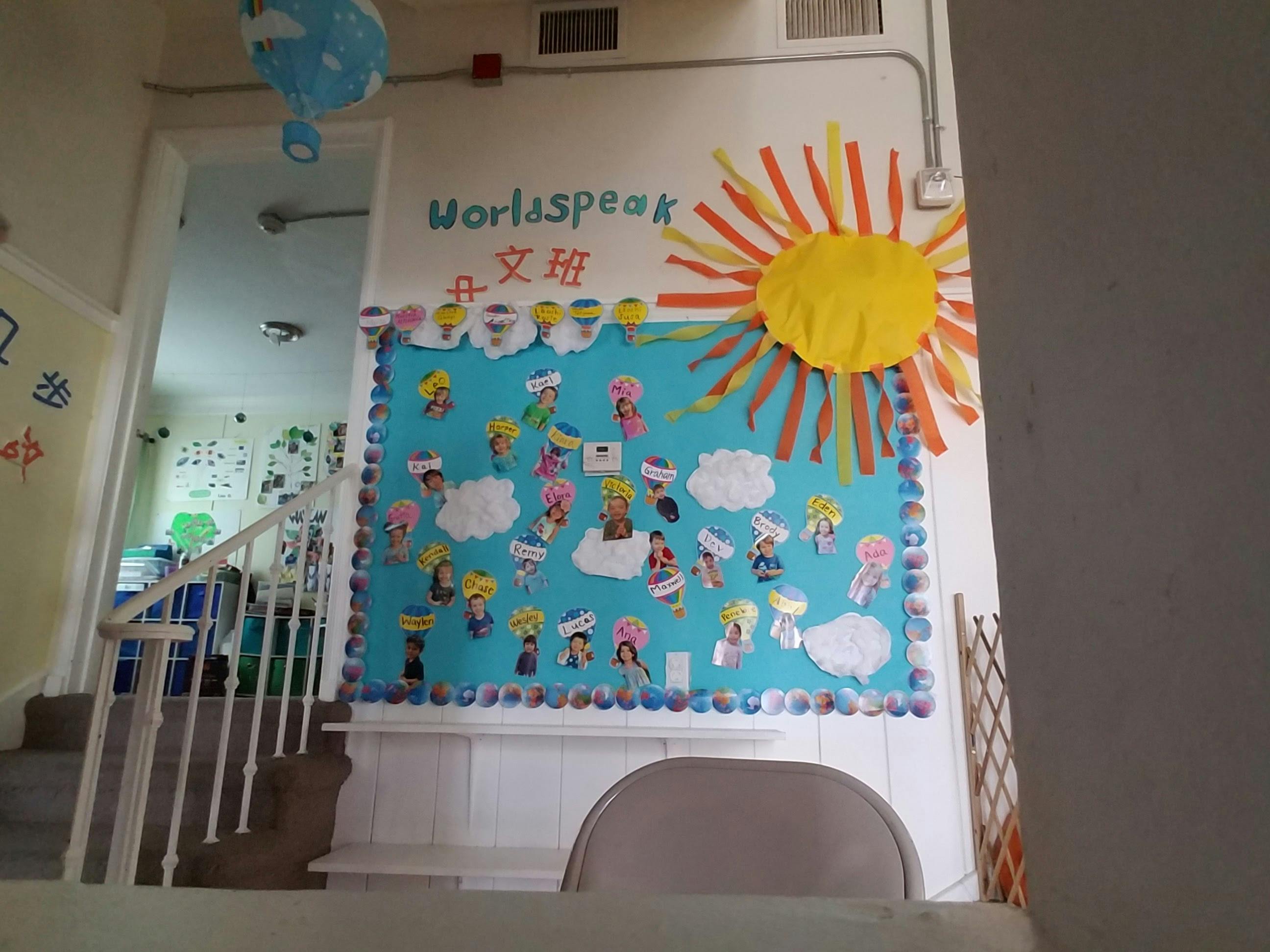 Worldspeak bulletin board with sun and diverse paper cutouts