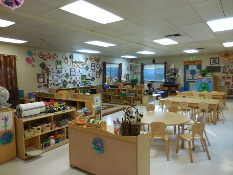 Empty classroom with small tables and chairs