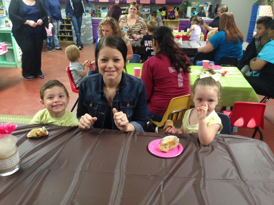 Person and two children sitting at a table