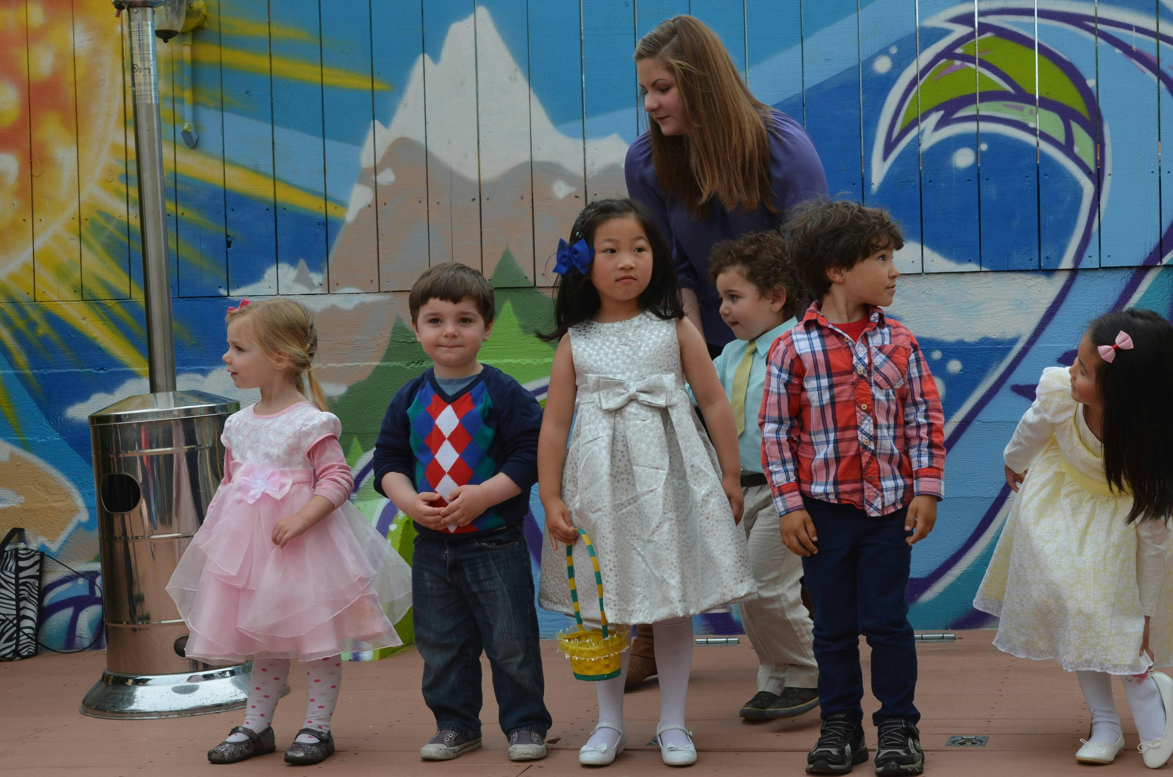 Adult and multiple children standing together