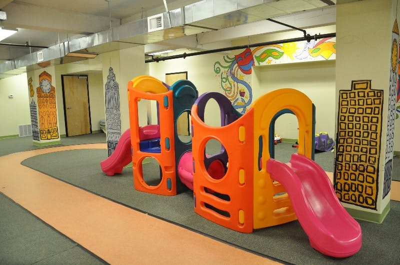 Colorful indoor playground structure with slides