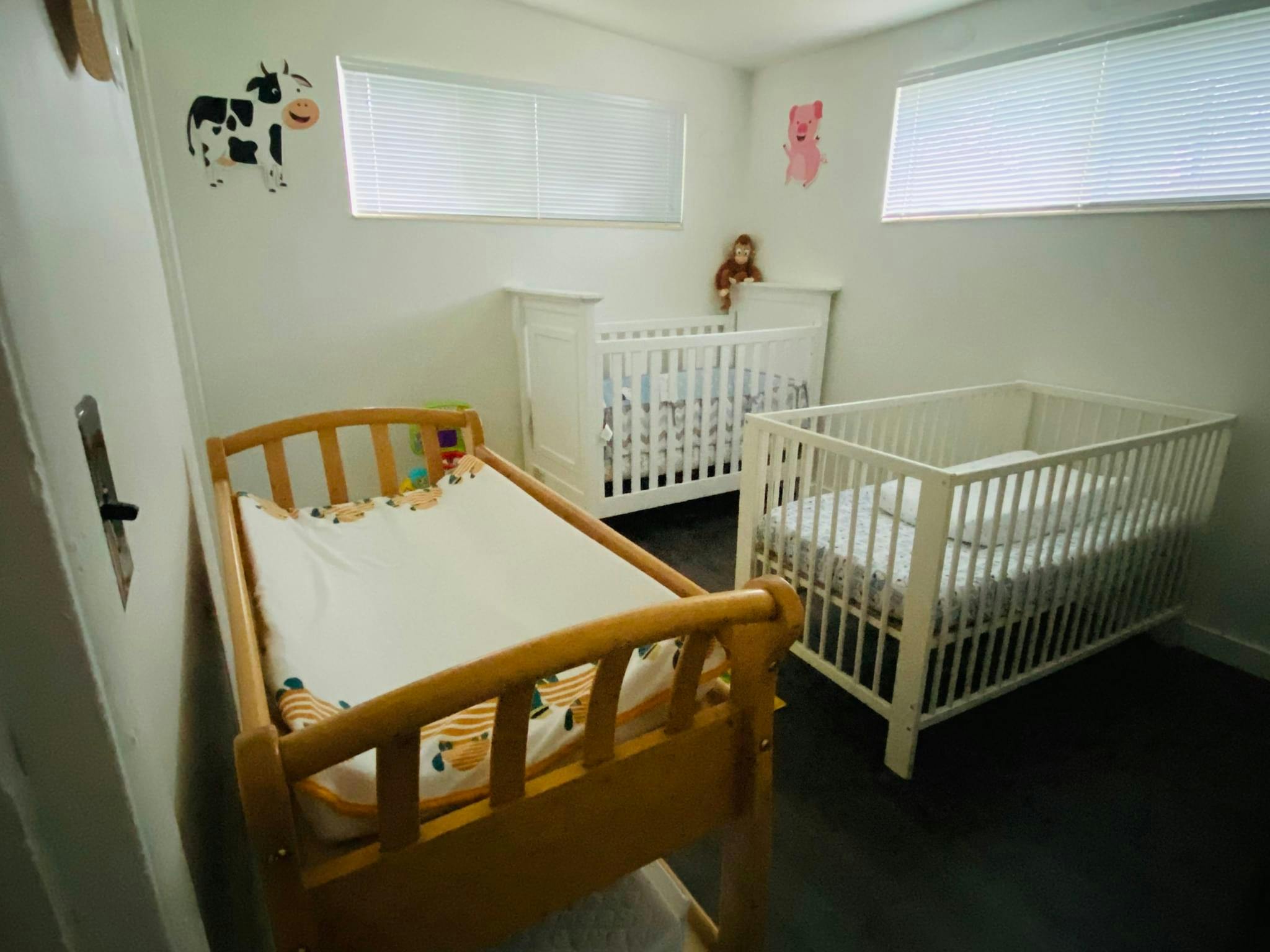 Three cribs in a room