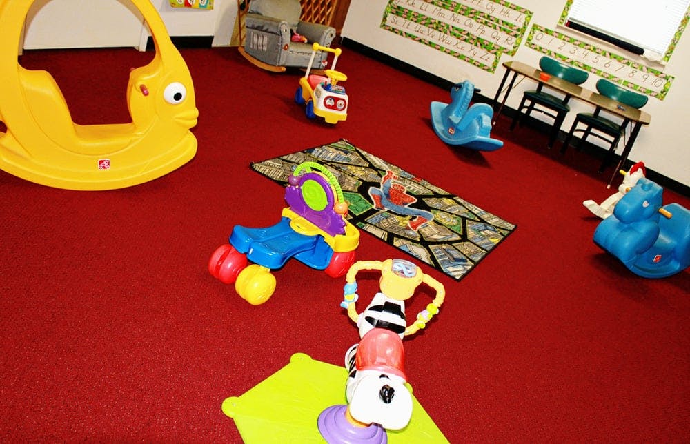Playroom with various colorful toys on a red carpet