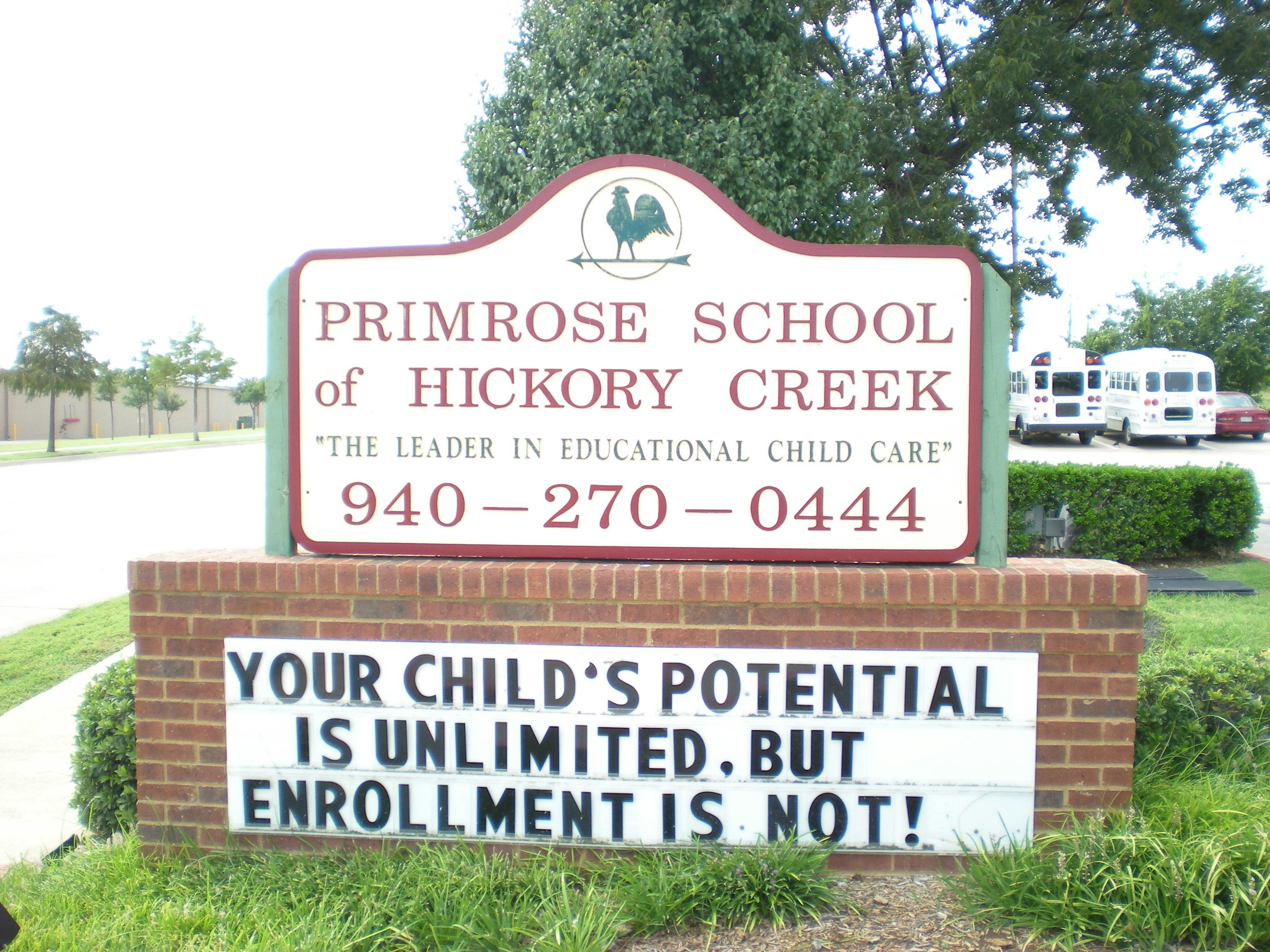 Primrose School of Hickory Creek sign with phone number and enrollment message