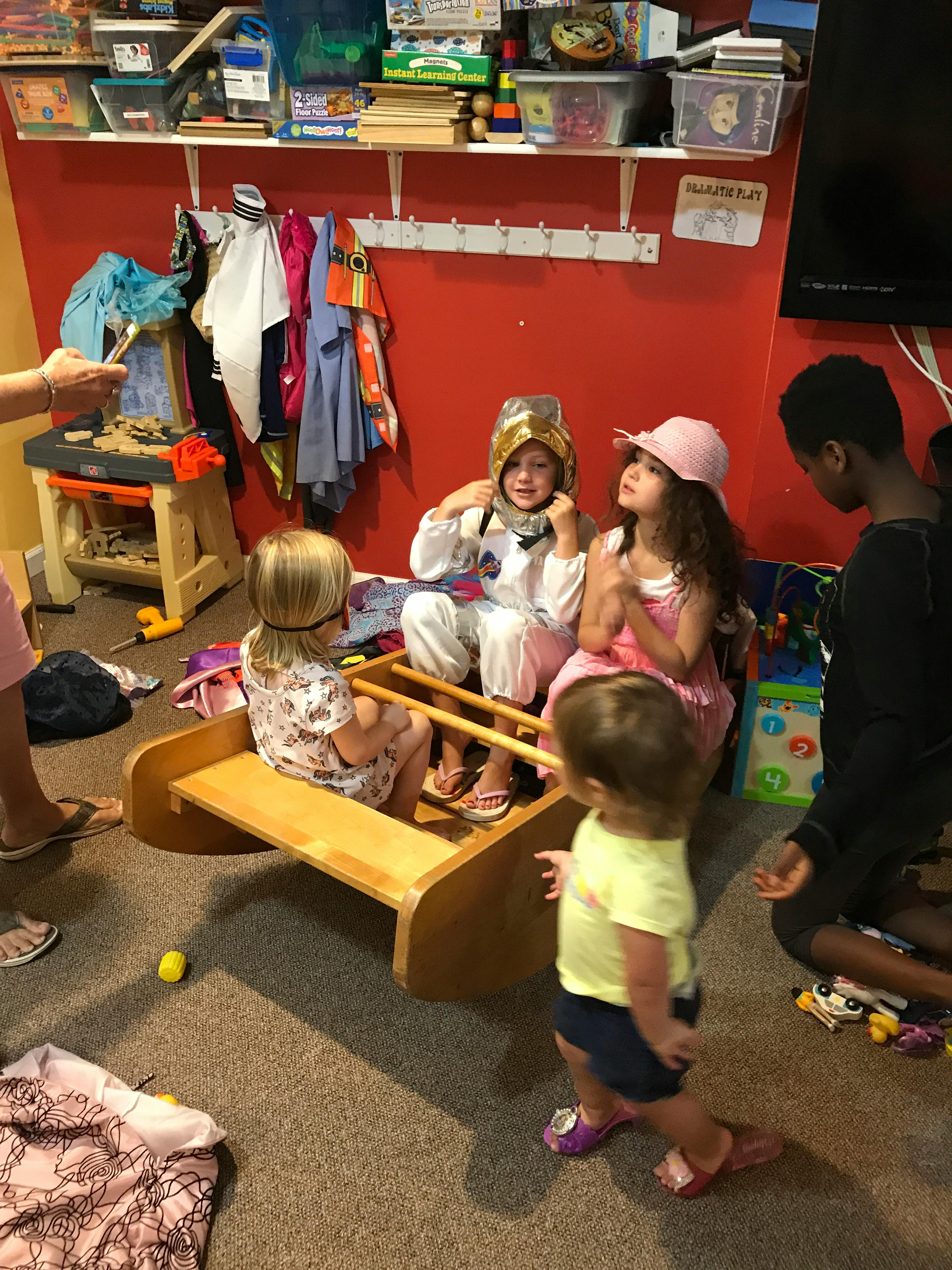 Children playing in a room, one child in an astronaut costume