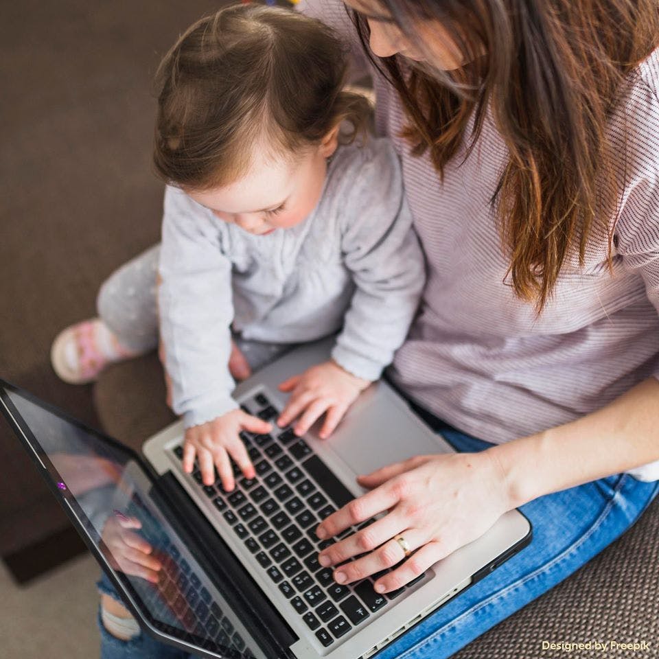 Person and child typing on a laptop