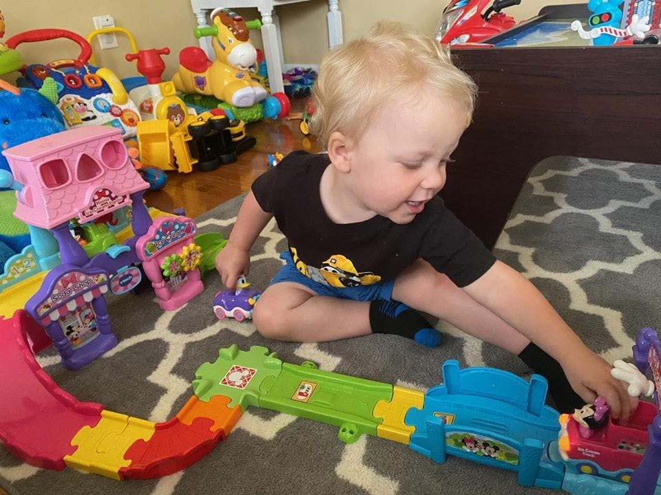 Child playing with toys on a rug