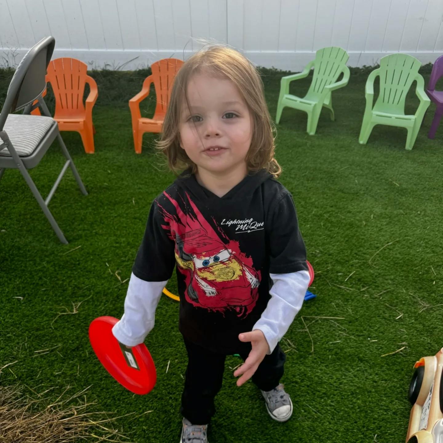 Child holding a red frisbee