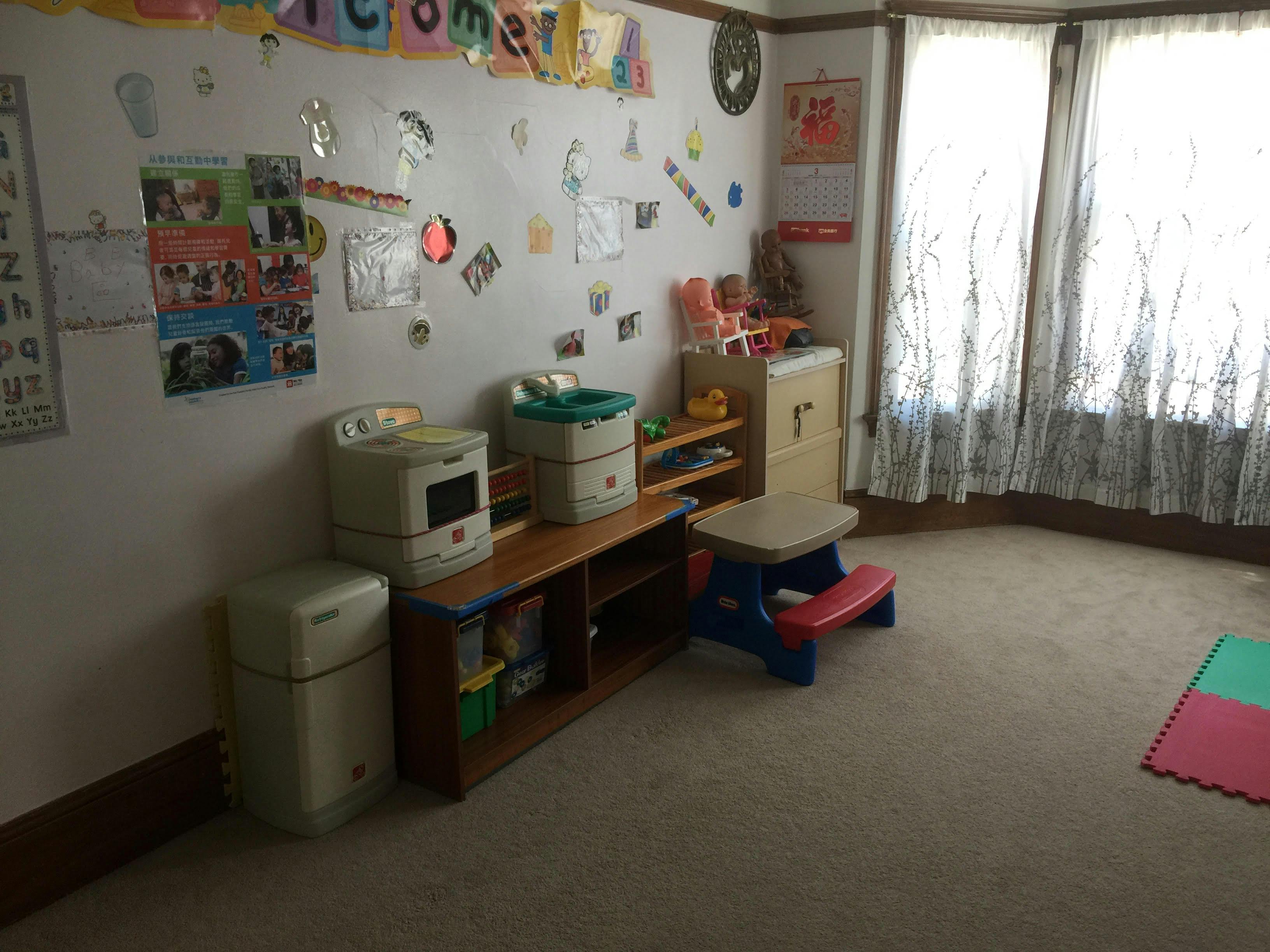 Playroom with toys, shelves, and a window with curtains