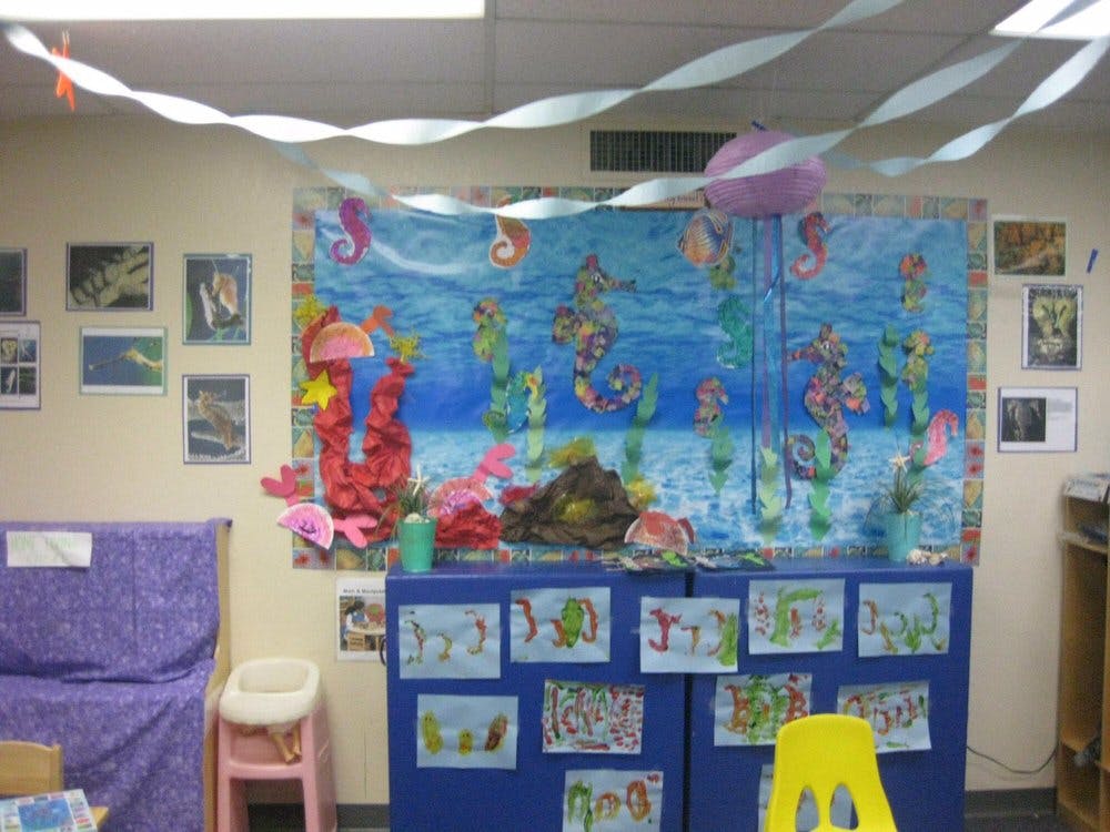 Classroom with an ocean-themed bulletin board and children's drawings