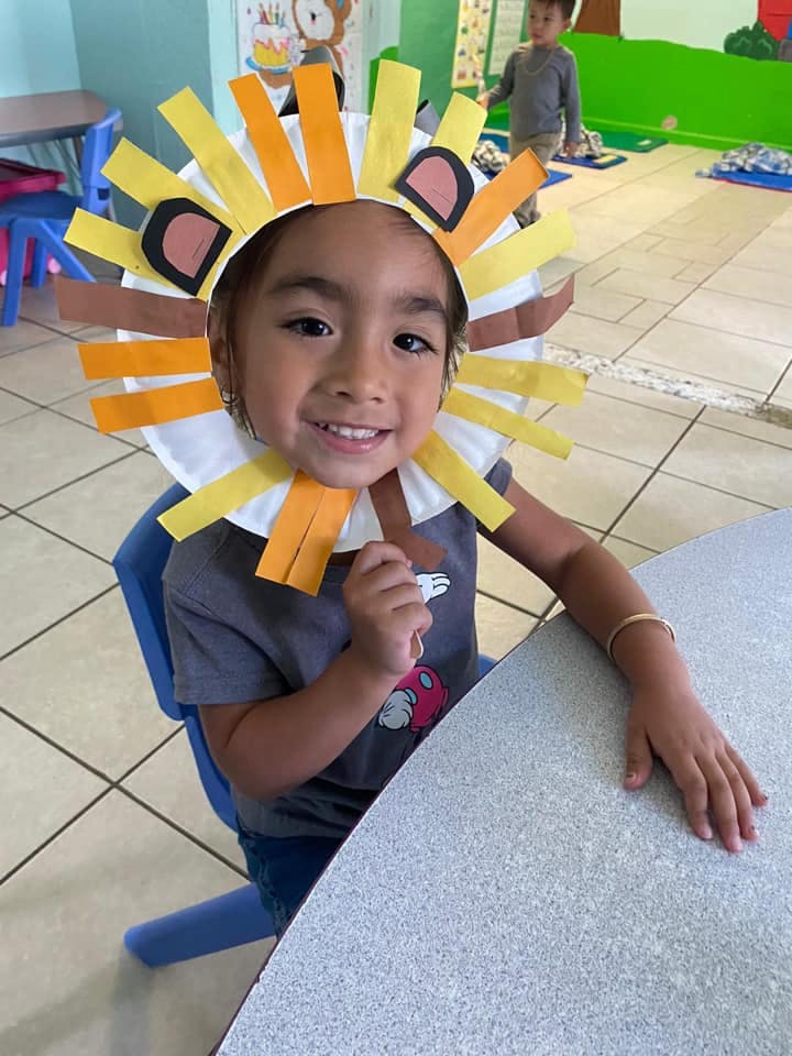 Child wearing a paper lion's mane