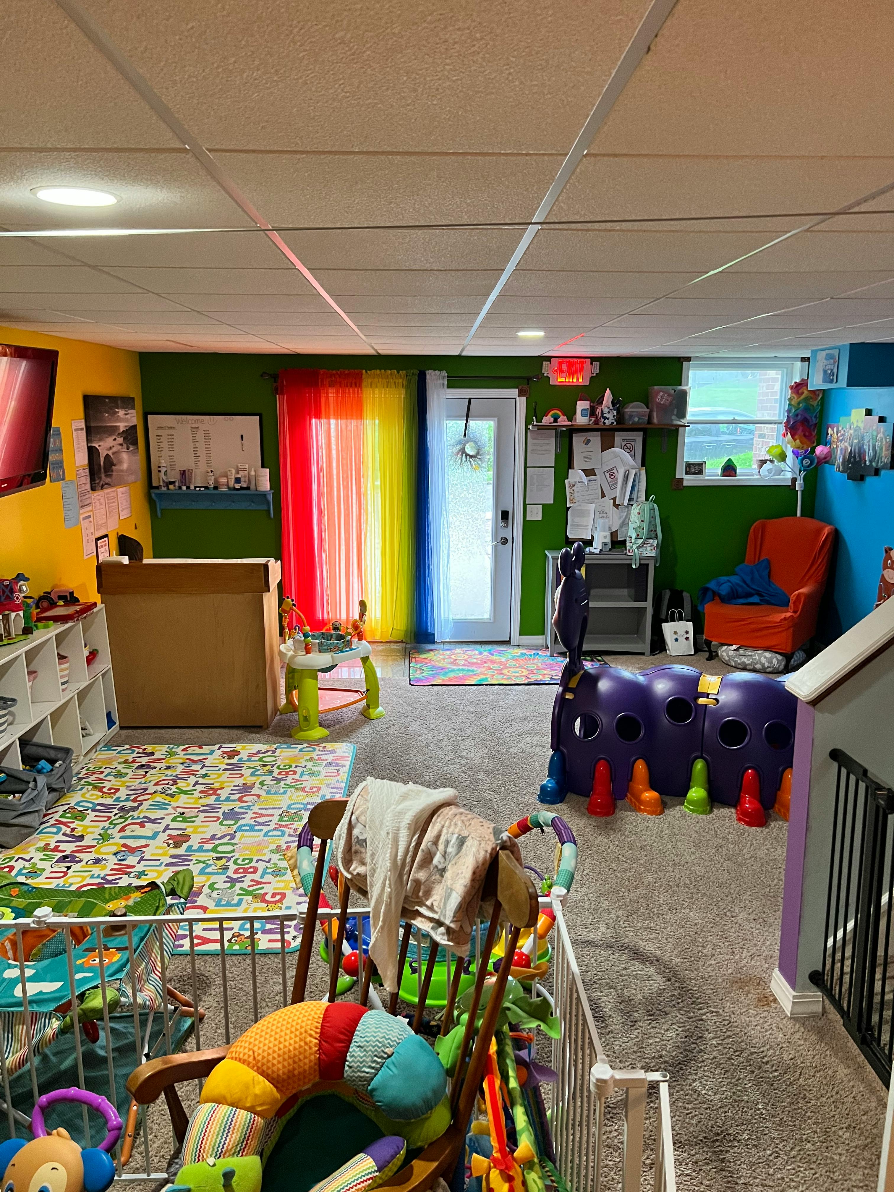 A colorful playroom with various toys and furniture for children
