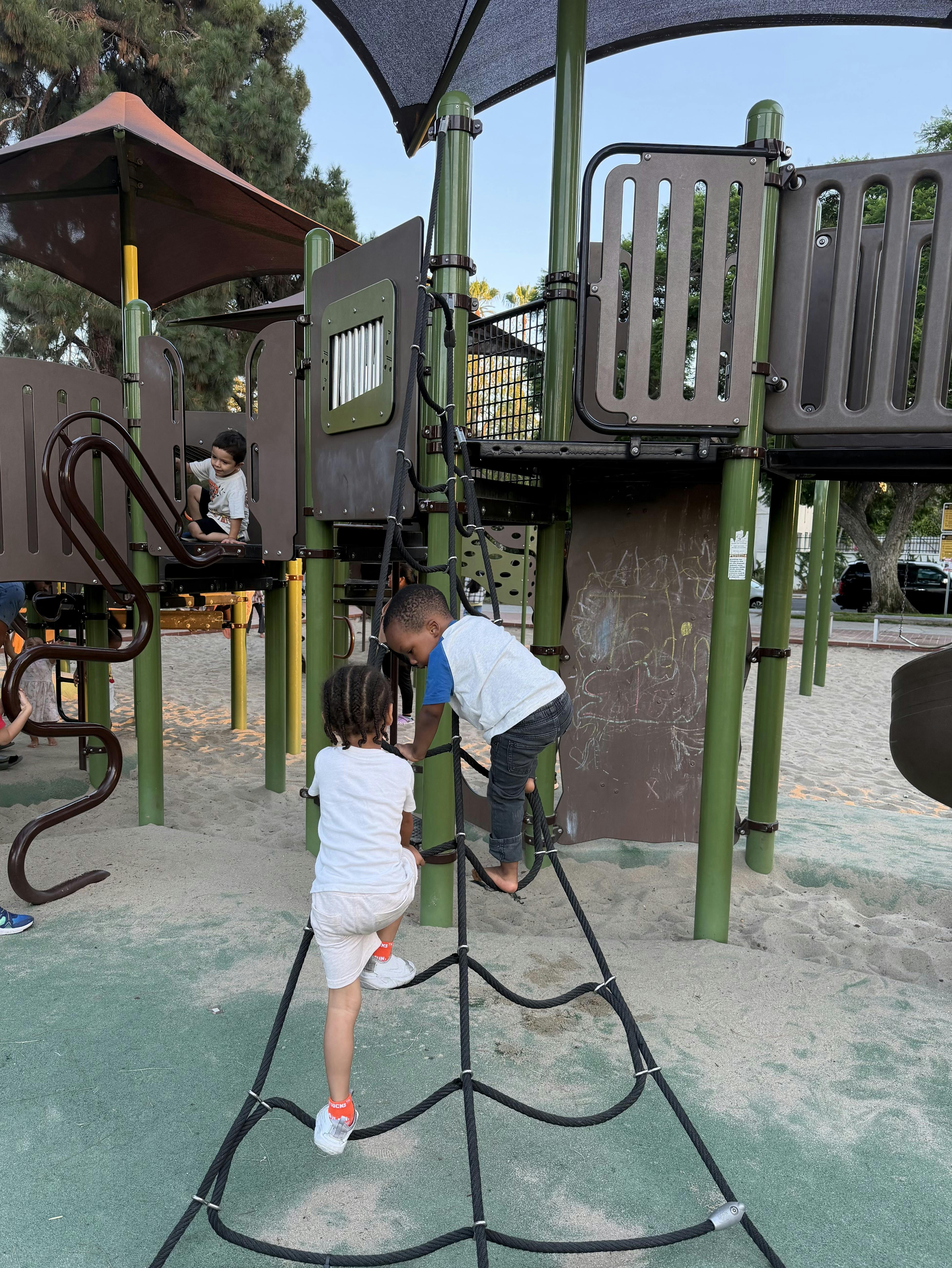 Children climbing on a rope net at a playground