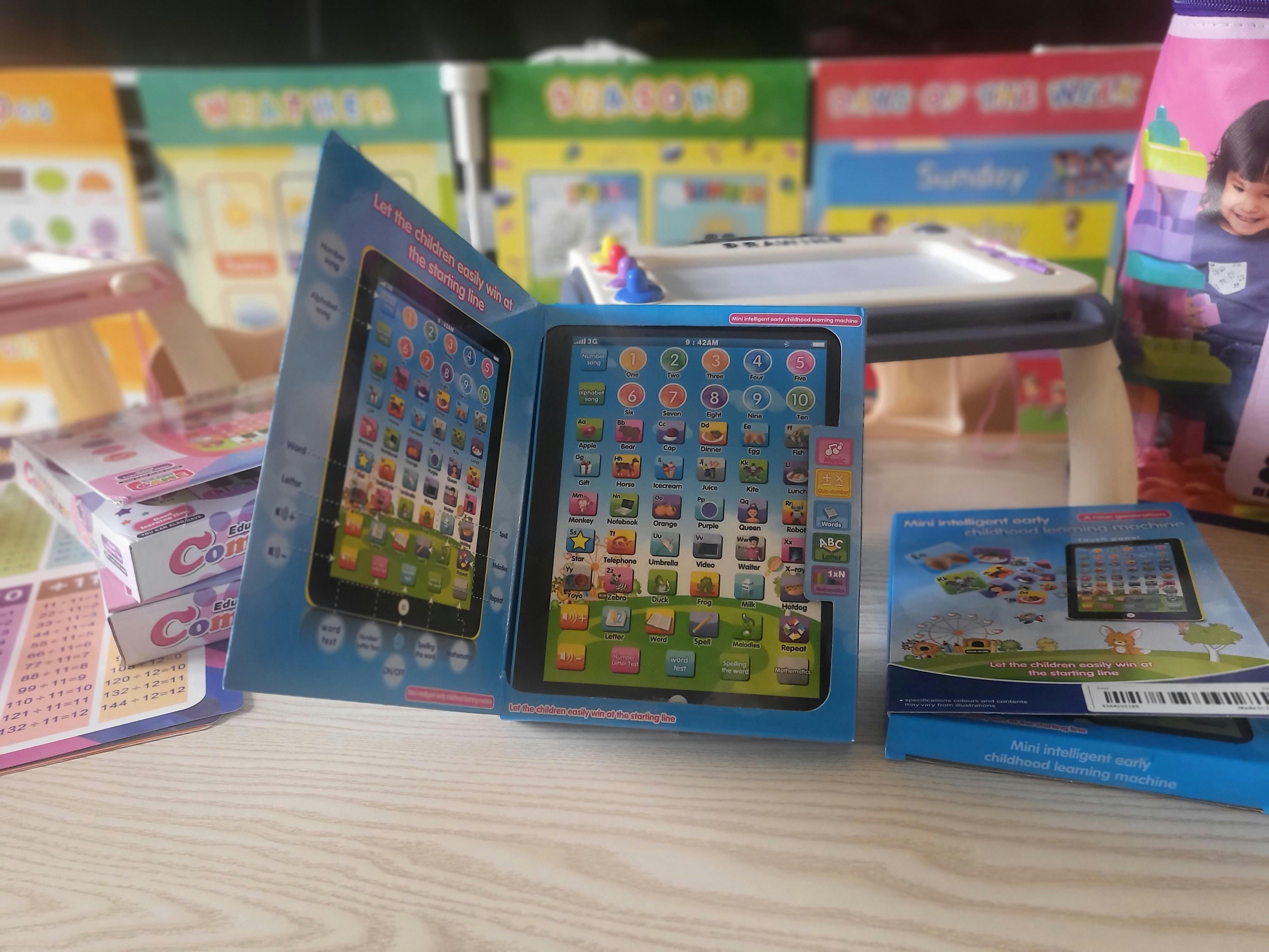 Open box for a toy tablet with app icons on screen