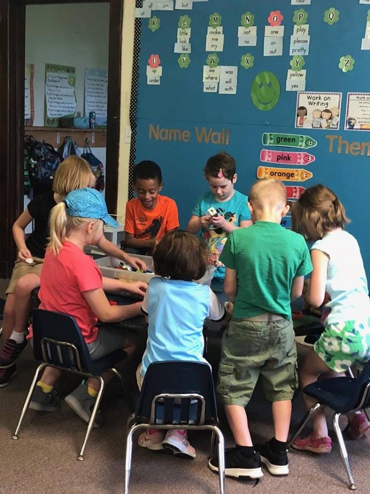 Children sitting around a table in a classroom