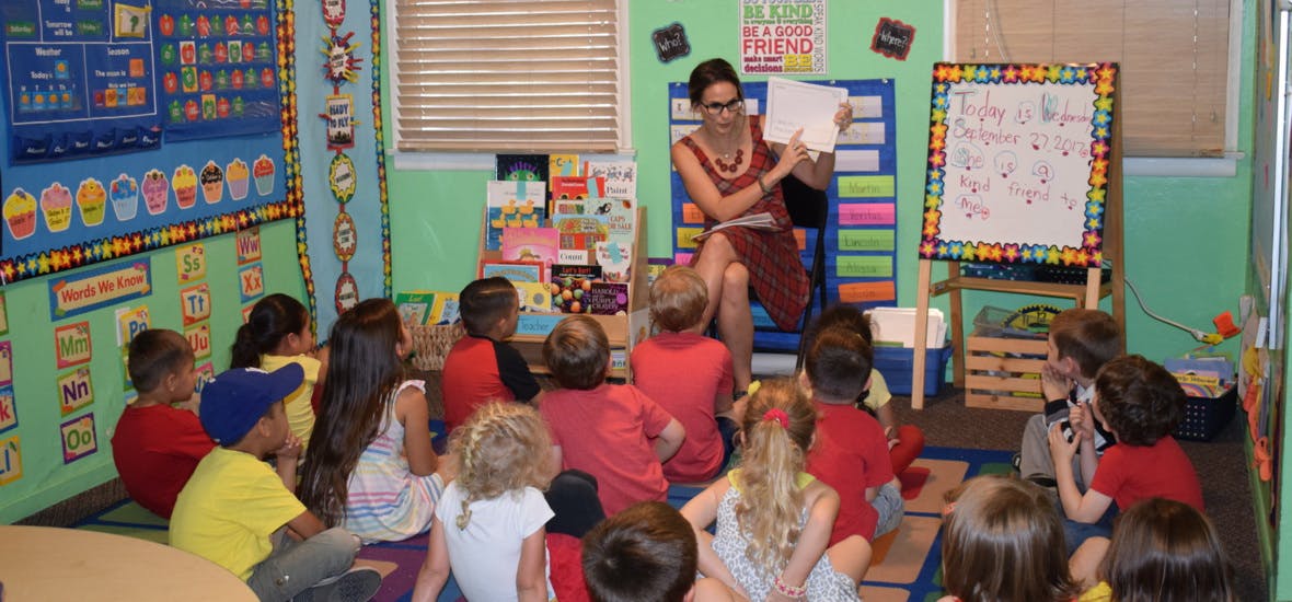 Person reading to children in a classroom