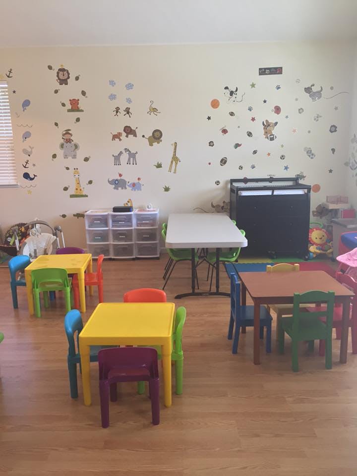 Classroom with small tables and chairs, animal wall decals