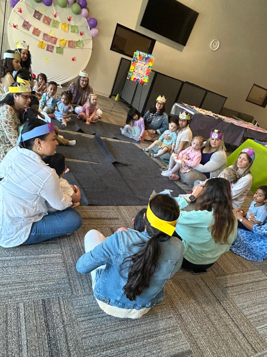 People and children sitting on the floor in a circle
