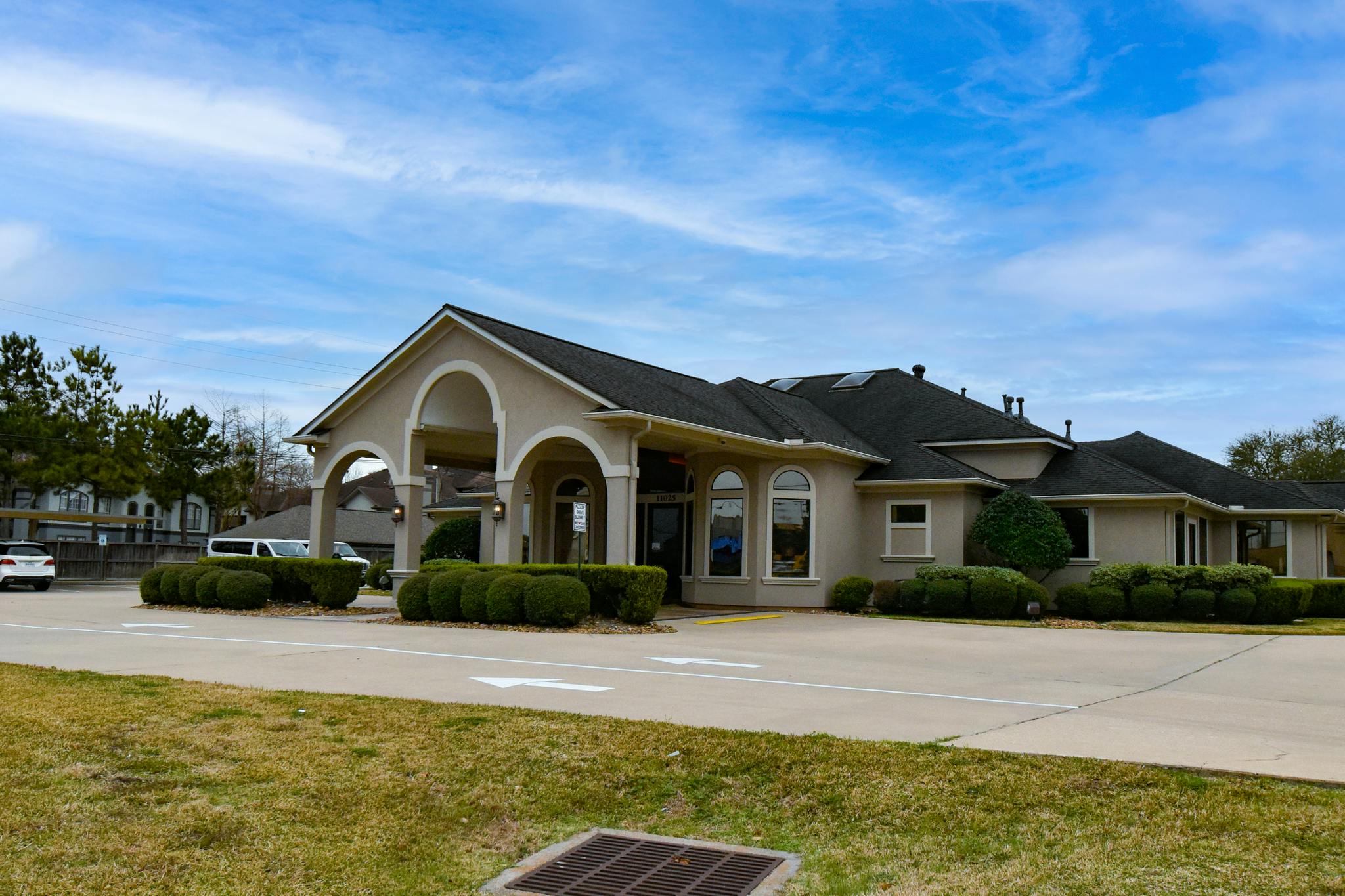 Building with arched entrance and dark roof