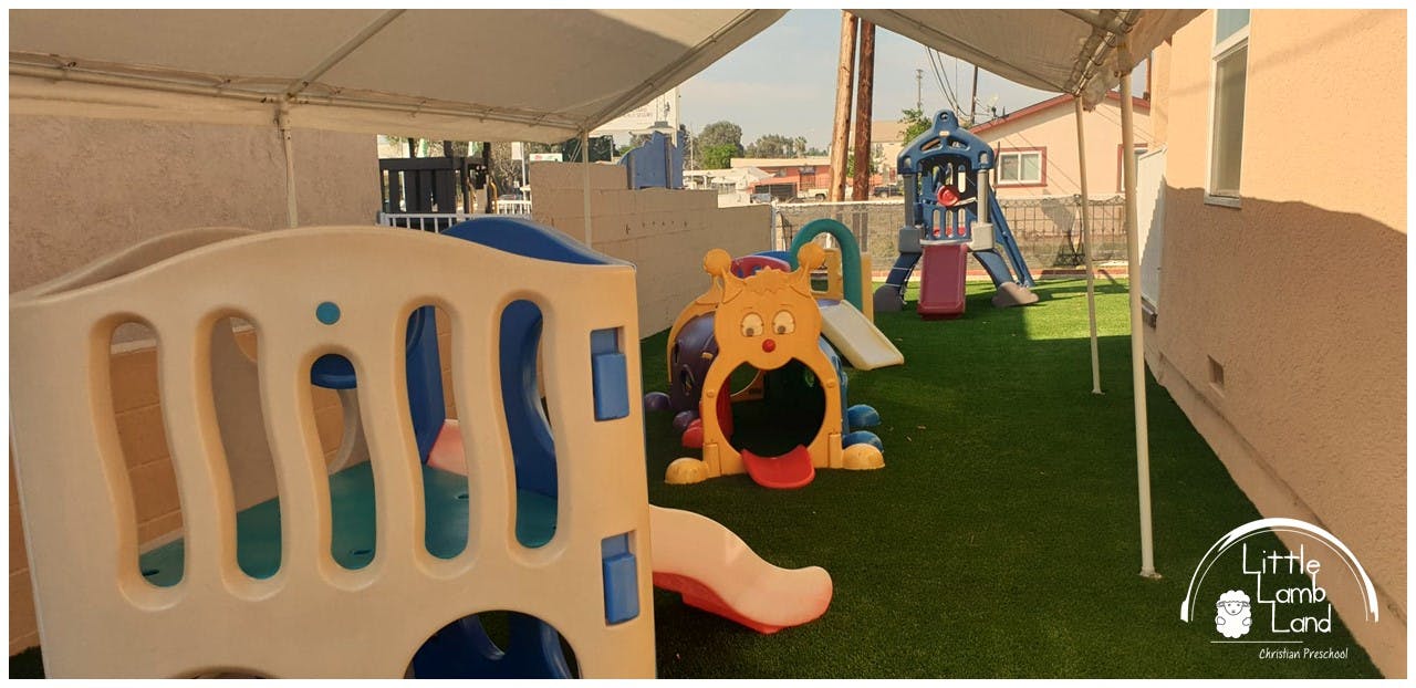 Outdoor playground with various colorful play structures on artificial turf